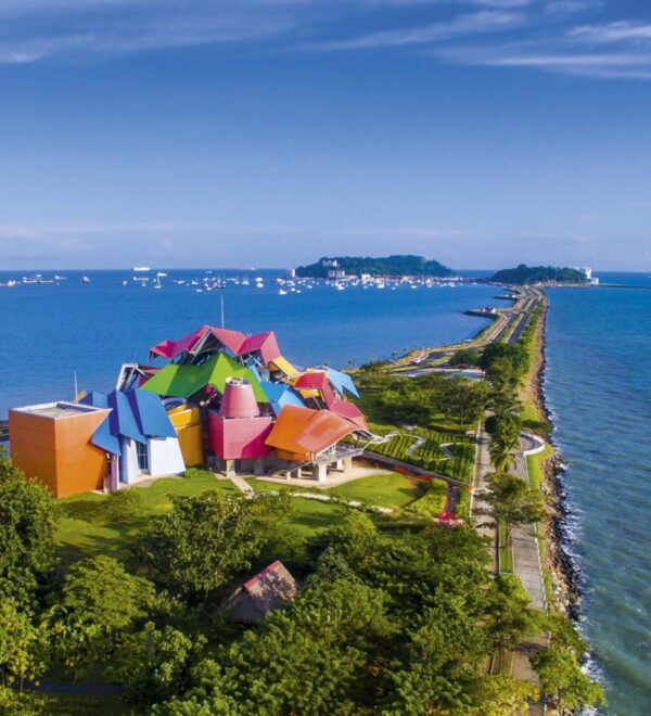 A colorful building on the edge of an ocean.