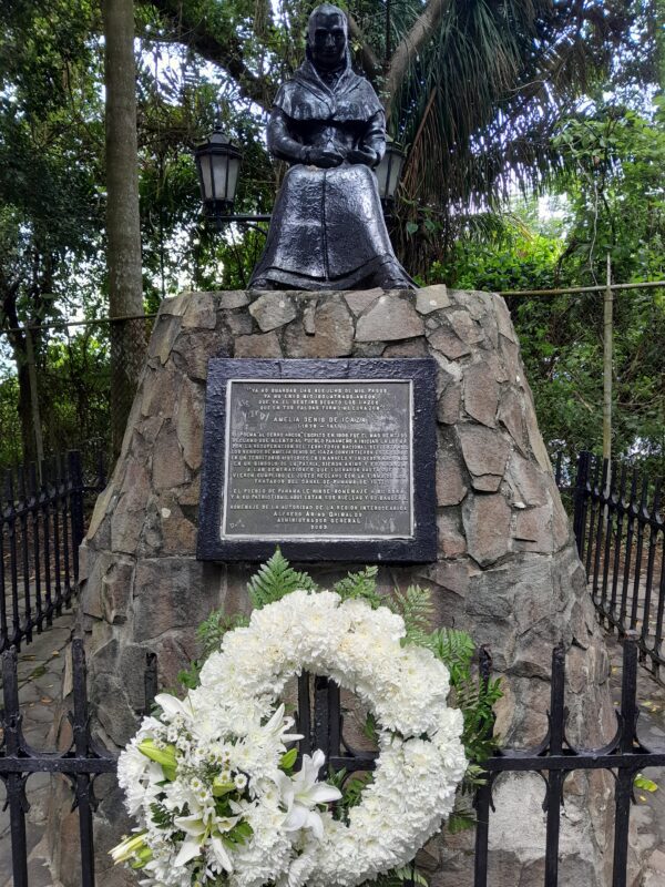 A memorial with a wreath and a plaque.