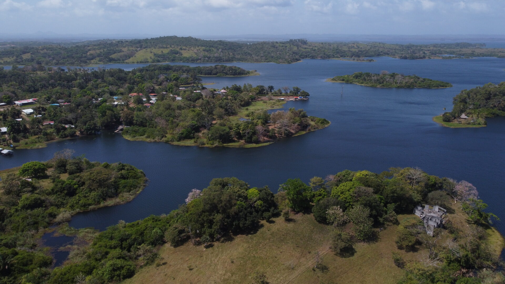 Aerial view of a lush island surrounded by calm blue waters.