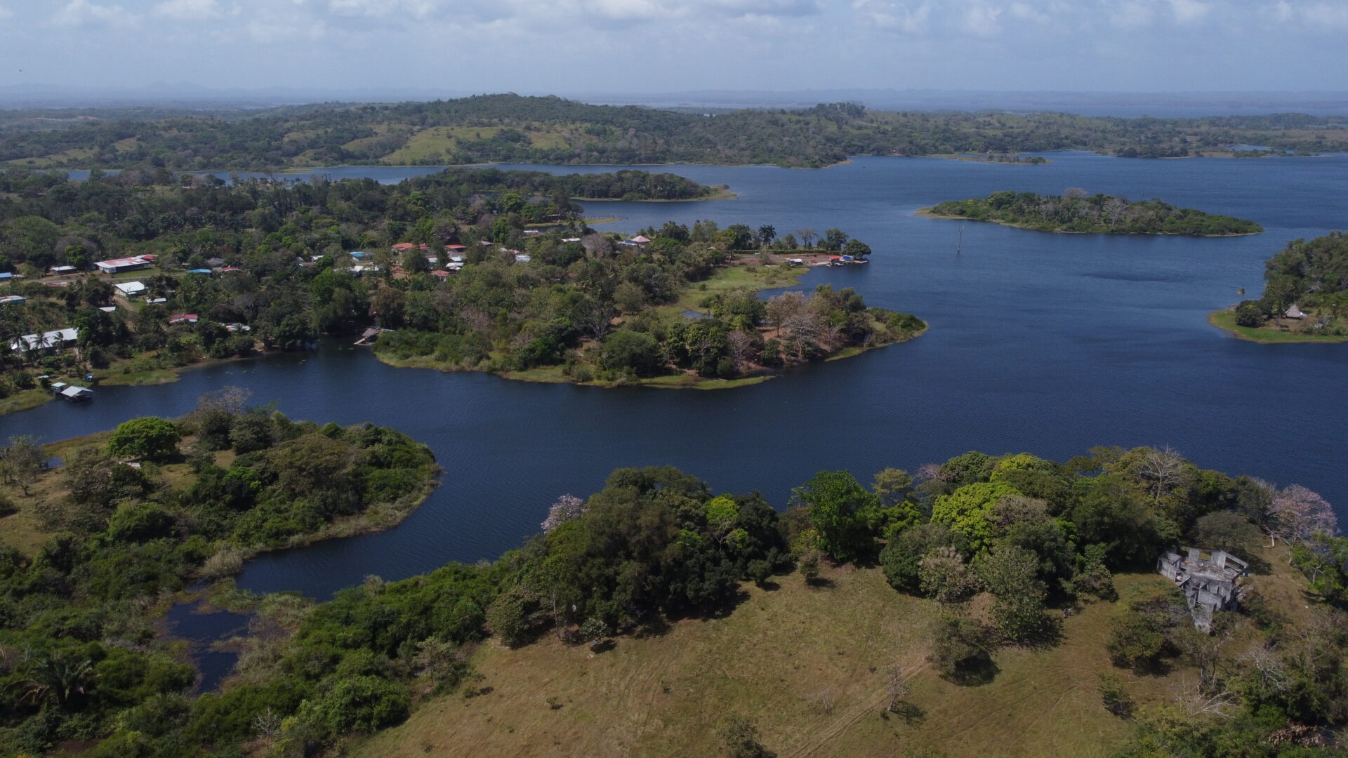 Aerial view of a lush island landscape surrounded by blue water.