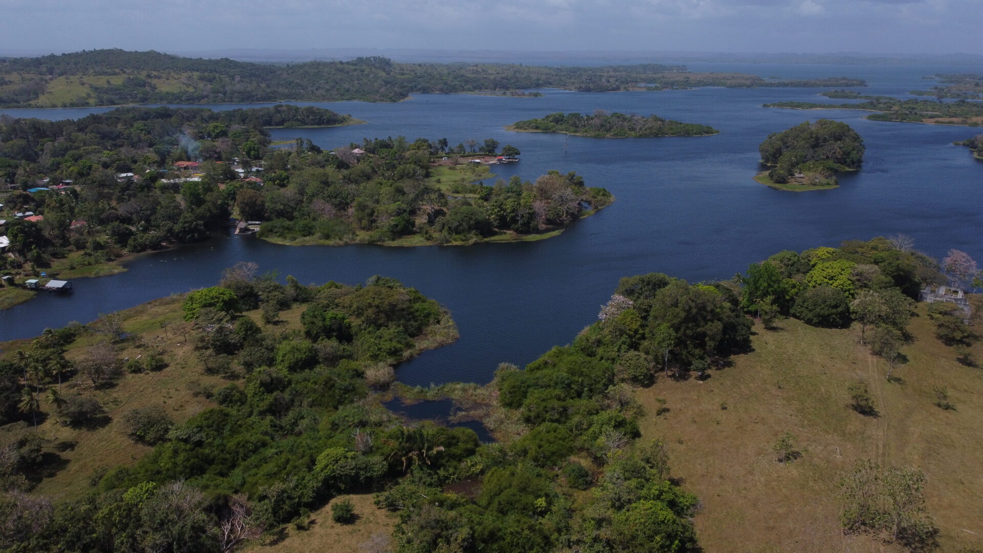 Aerial view of a river with lush green islands and surrounding landscape.