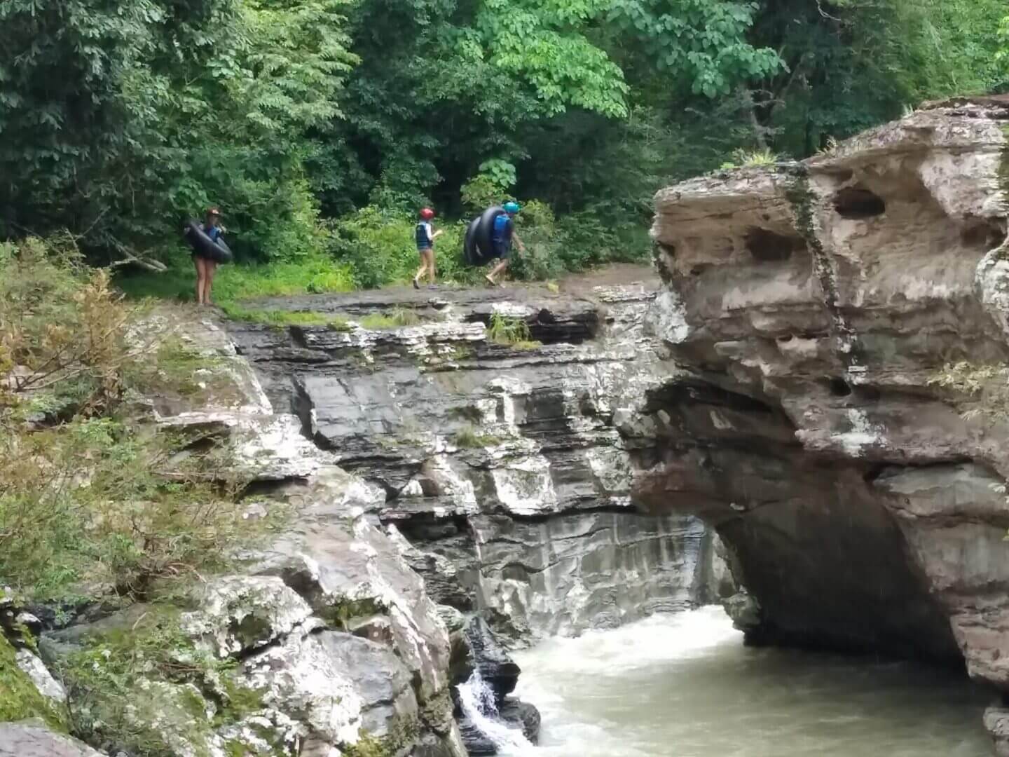 A group of people standing on top of rocks.
