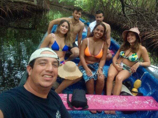 A group of people in the water on a boat.