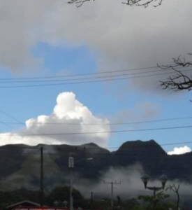 A cloud formation is seen in the distance.