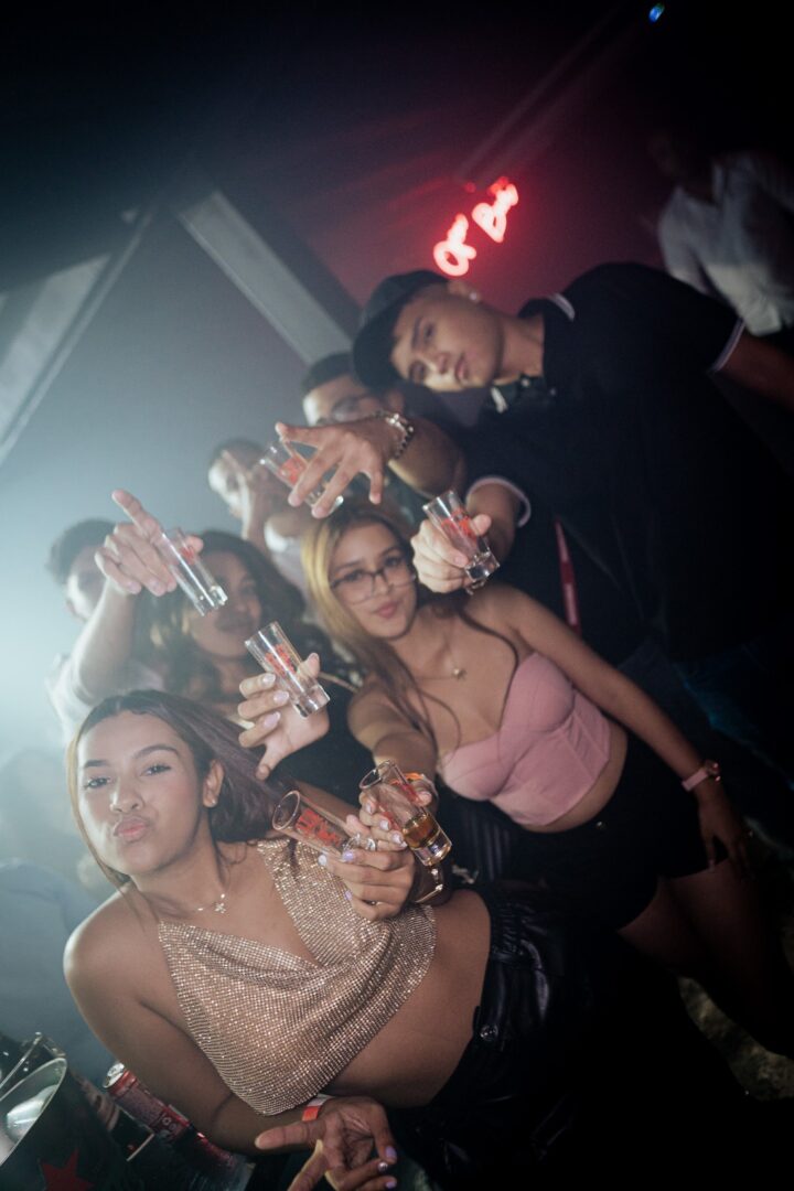 Group of friends enjoying drinks at a lively party.