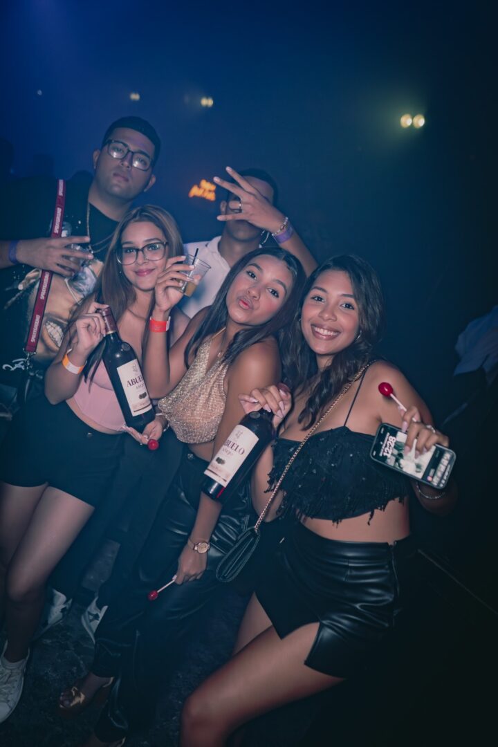 Four friends enjoying a night out with drinks and fun.