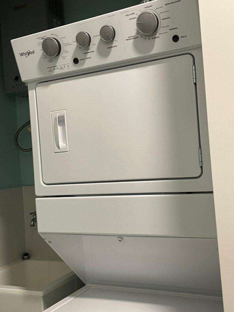 White front-loading dryer with control knobs on top.