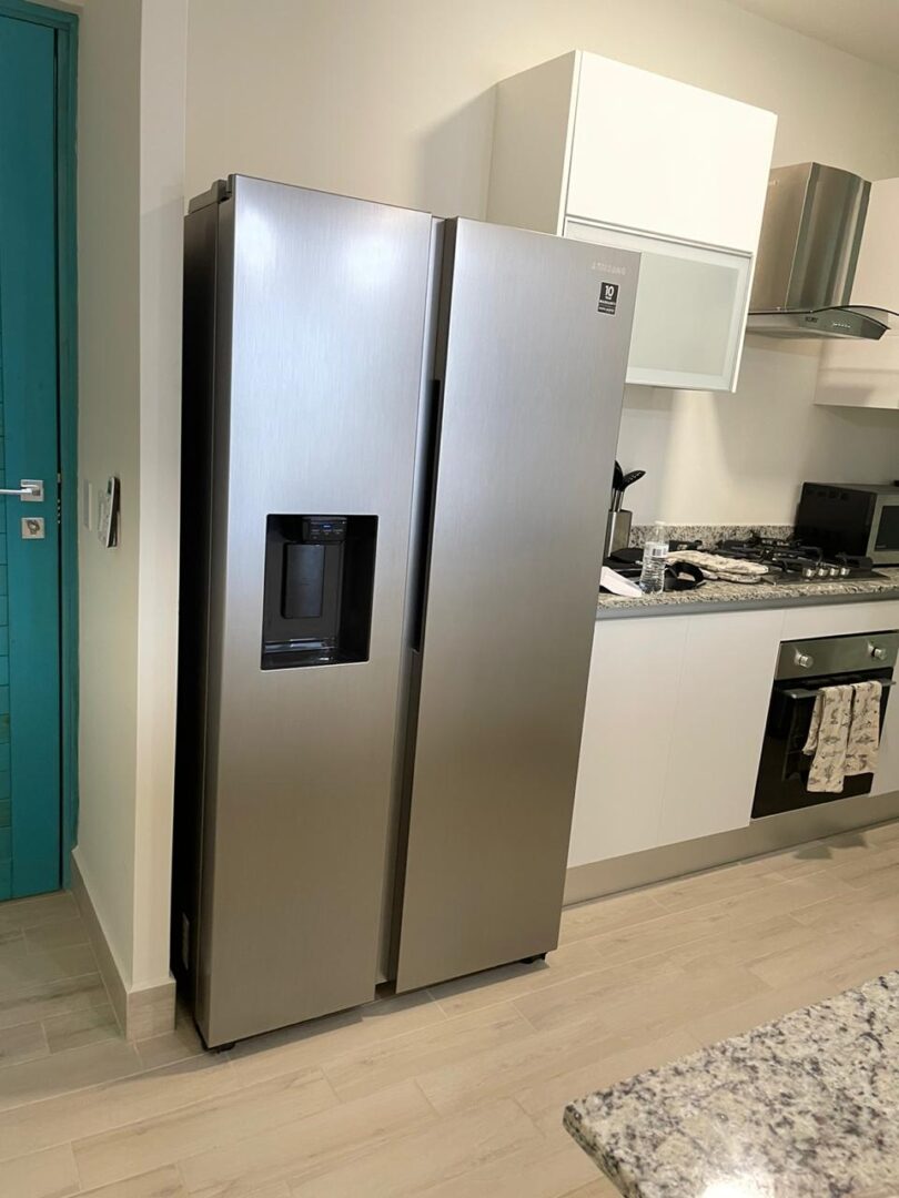 Modern stainless steel side-by-side refrigerator in a sleek kitchen.