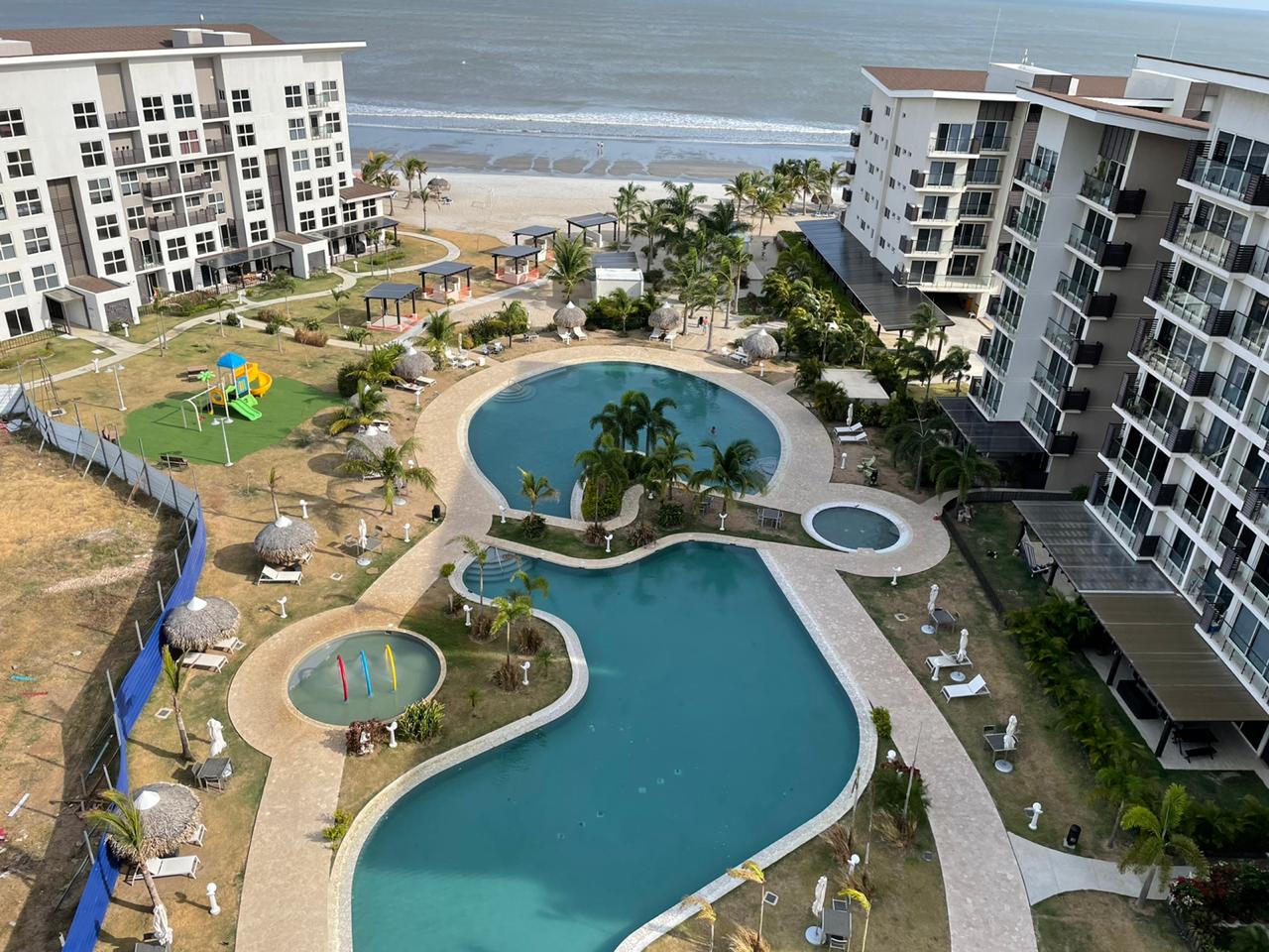 Oceanfront resort with a pool and playground.
