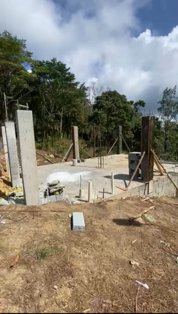 Foundation and walls being constructed at a rural building site.