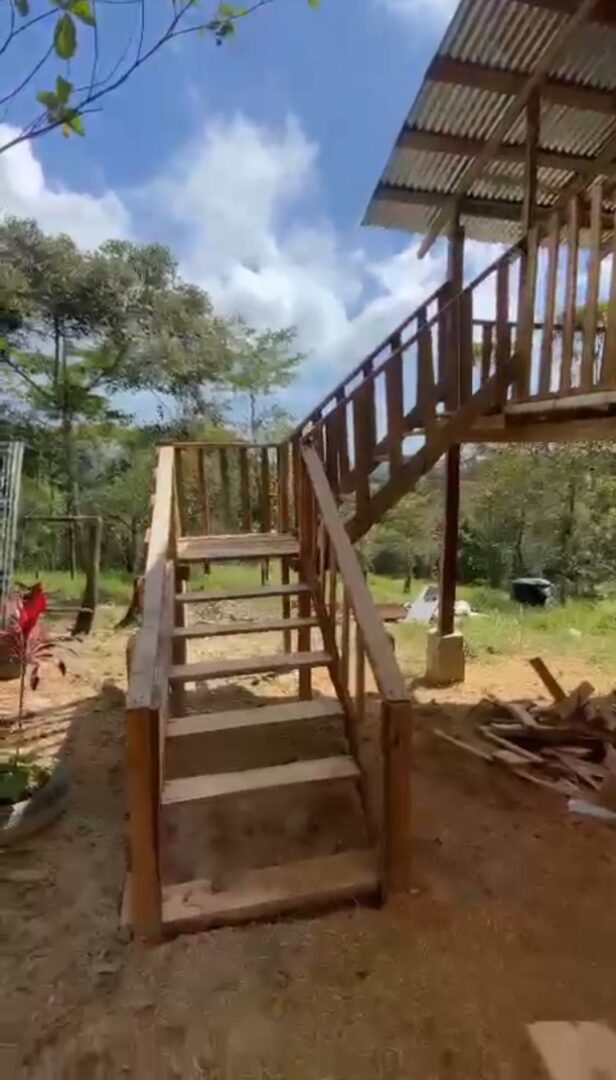 Wooden staircase under construction outdoors.